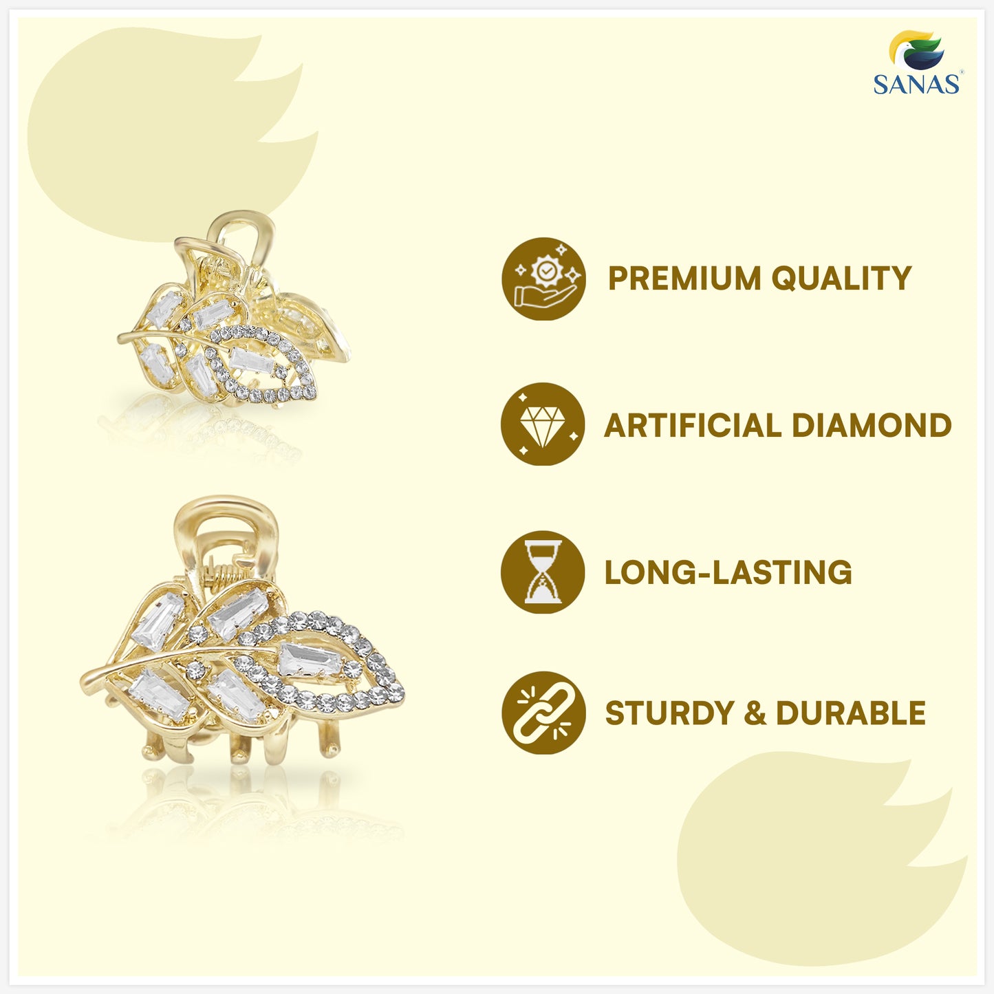 Gold leaf-shaped pendant with artificial diamonds on a light yellow background, featuring SANAS brand.