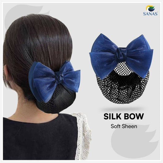 Blue silk bow hair accessory worn by a person with a close-up of the bow on a white background.