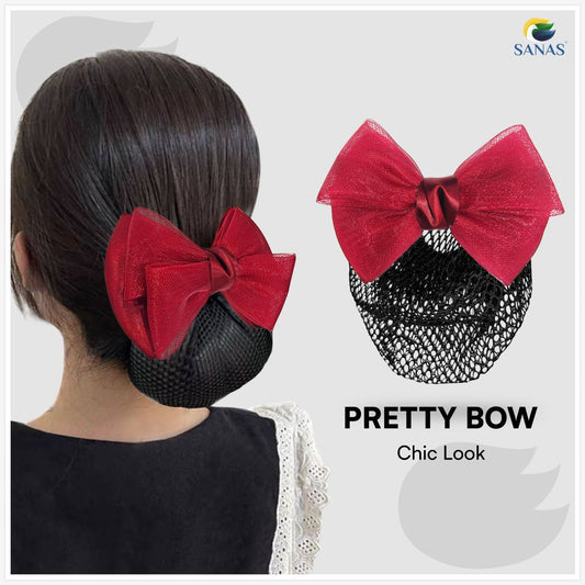 Red bow hair accessory on a black mesh bun with 'SANAS' branding.