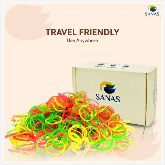 Box of colorful rubber bands with 'SANAS' branding on a light pink background
