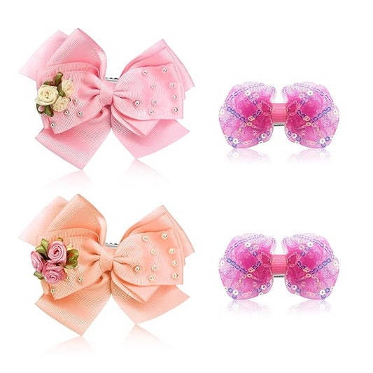 Two pairs of pink hair bows with floral decorations on a white background