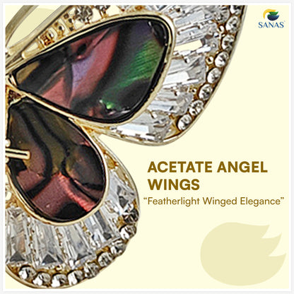 Gold and crystal sunglasses with 'Acetate Angel Wings' text on a light yellow background