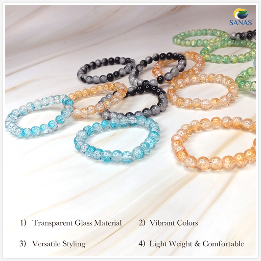 Set of beaded bracelets in various colors on a light wooden surface with 'SANAS' branding.