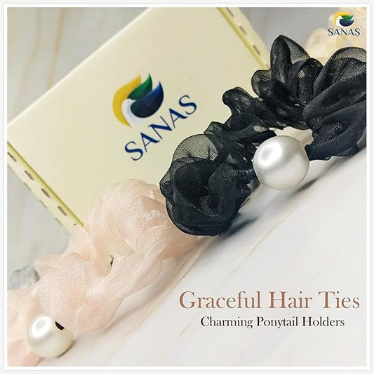 Black hair ties with pearls on a white surface, featuring the SANAS brand. Soft satin scrunchie set for ponytail and bun hairstyles